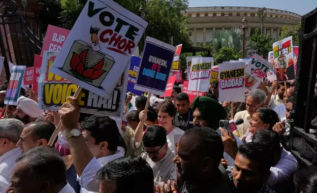 Congress party leader Priyanka Gandhi Vadra, center, and others hold placards as they march during a protest organized by opposition parties in New Delhi, India, Tuesday, Oct. 6, 2026. (AP Photo/Manish Swarup)