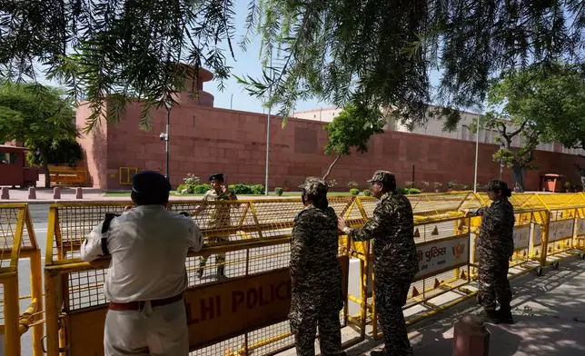 Police officers stand guard around Parliament ahead of a protest organized by opposition parties in New Delhi, India, Tuesday, Oct. 6, 2026. (AP Photo/Manish Swarup)