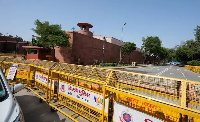 Police officers stand guard around Parliament ahead of a protest organized by opposition parties in New Delhi, India, Tuesday, Oct. 6, 2026. (AP Photo/Manish Swarup)