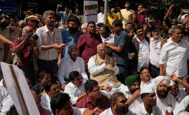 Congress party President Mallikarjun Kharge, center, claps while seated during a protest organized by opposition parties in New Delhi, India, Tuesday, Oct. 6, 2026. (AP Photo/Manish Swarup)