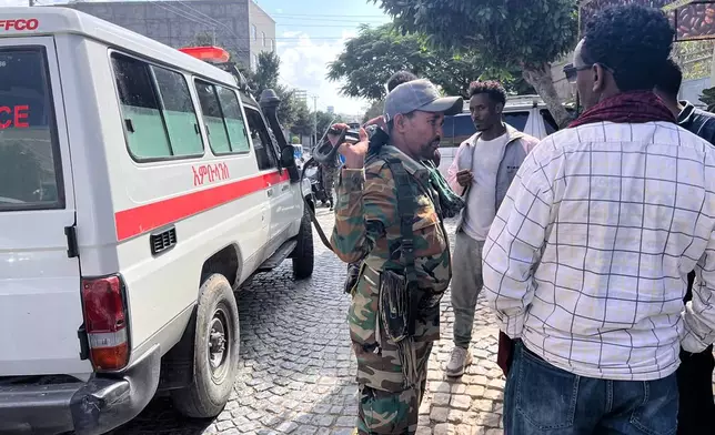Tigray Peace Force fighters stand beside an ambulance after entering Mekelle, in Ethiopia’s Tigray region, Sunday, Oct. 4, 2026. (AP Photo/Filmon Equar Hailu)