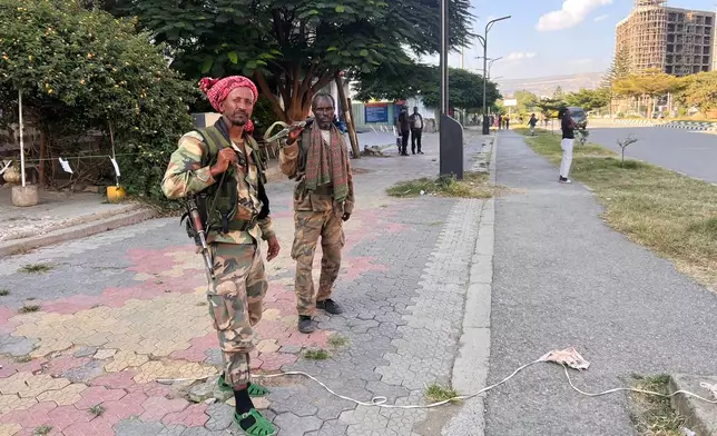 Tigray Peace Force fighters stand in a road after entering Mekelle, in Ethiopia's Tigray region, Sunday, Oct. 4, 2026. (AP Photo/Filmon Equar Hailu)