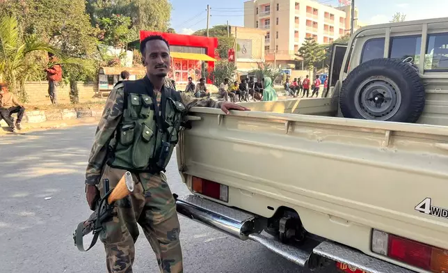Tigray Peace Force fighters stand in a road after entering Mekelle, in Ethiopia's Tigray region, Sunday, Oct. 4, 2026. (AP Photo/Filmon Equar Hailu)