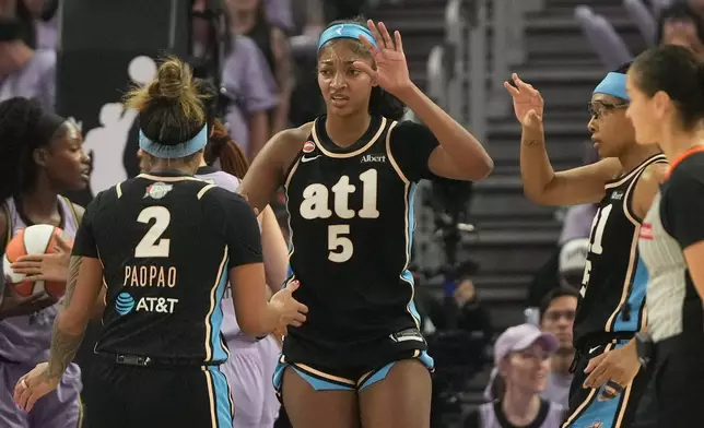 Atlanta Dream forward Angel Reese (5) celebrates with guard Te-Hina Paopao (2) and guard Allisha Gray, right, during the first half of Game 5 of the WNBA basketball finals against the Golden State Valkyries, Monday, Oct. 26, 2026, in San Francisco. (AP Photo/Jeff Chiu)
