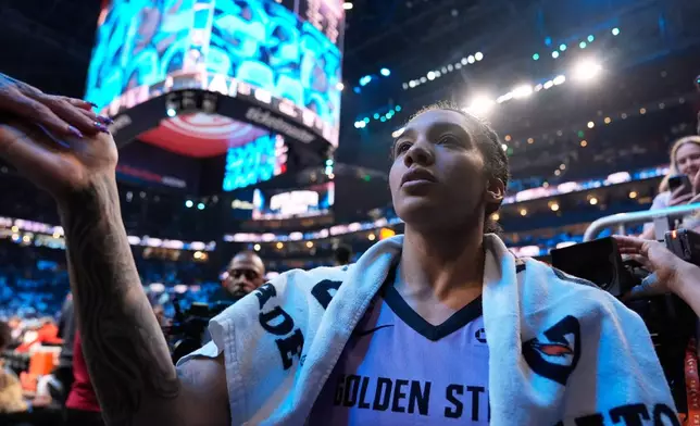 Golden State Valkyries forward Gabby Williams (1) high fives fans after Game 4 of the WNBA basketball finals against the Atlanta Dream on Saturday, Oct. 24, 2026, in Atlanta. (AP Photo/Brynn Anderson)