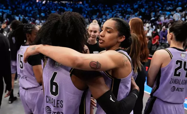 Golden State Valkyries forward Gabby Williams (1) hugs Golden State Valkyries guard Kaila Charles (6) after Game 4 of the WNBA basketball finals on Saturday, Oct. 24, 2026, in Atlanta. (AP Photo/Brynn Anderson)