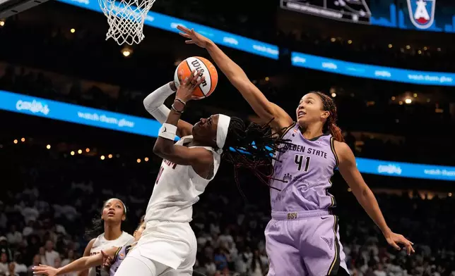 Atlanta Dream guard Rhyne Howard (10) attempts to shoot against Golden State Valkyries center Kiah Stokes (41) in the second half during Game 4 of the WNBA basketball finals on Saturday, Oct. 24, 2026, in Atlanta. (AP Photo/Brynn Anderson)