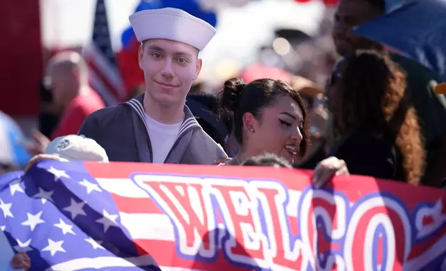 Family and friends gather to welcome sailor Frankie Valdovinos as the USS Abraham Lincoln aircraft carrier returns to Naval Air Station North Island after deployment Thursday, Oct. 8, 2026, in Coronado, Calif. (AP Photo/Gregory Bull)
