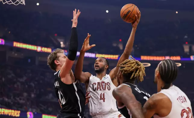 Cleveland Cavaliers center Evan Mobley (4) drives against Brooklyn Nets center Moritz Wagner, left, in the first half of an NBA basketball game in Cleveland, Saturday, Oct. 24, 2026. (AP Photo/Tim Phillis)