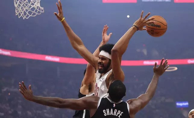 Cleveland Cavaliers center Jarrett Allen is fouled by Brooklyn Nets center Day'ron Sharpe (20) in the first half of an NBA basketball game in Cleveland, Saturday, Oct. 24, 2026. (AP Photo/Tim Phillis)