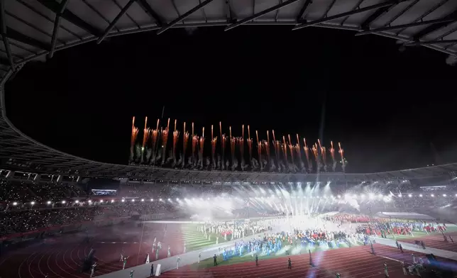 Fireworks explode from the roof of the stadium during during the closing ceremony for the Asian Games in Nagoya, Japan, Sunday, Oct. 4, 2026. (AP Photo/Aaron Favila)