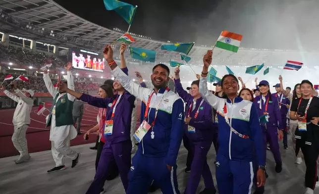 Athletes from India walk with fellow athletes as they leave the arena following the closing ceremony for the Asian Games in Nagoya, Japan, Sunday, Oct. 4, 2026. (AP Photo/Lee Jin-man)
