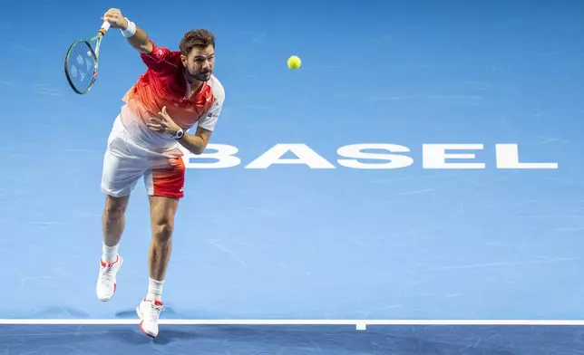 Switzerland's Stan Wawrinka serves to Czech Republic's Jiri Lehecka during the first round of the Swiss Indoors tennis tournament in Basel, Switzerland, Tuesday, Oct. 27, 2026. (Georgios Kefalas/Keystone via AP)