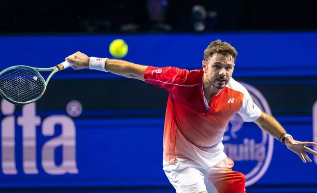 Switzerland's Stan Wawrinka returns a shot to Czech Republic's Jiri Lehecka during the first round of the Swiss Indoors tennis tournament in Basel, Switzerland, Tuesday, Oct. 27, 2026. (Georgios Kefalas/Keystone via AP)