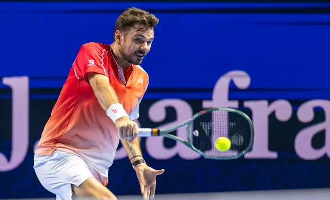 Switzerland's Stan Wawrinka returns a shot to Czech Republic's Jiri Lehecka during the first round of the Swiss Indoors tennis tournament in Basel, Switzerland, Tuesday, Oct. 27, 2026. (Georgios Kefalas/Keystone via AP)