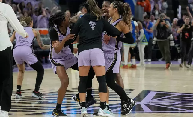 Golden State Valkyries guard Tiffany Hayes, from left, celebrates with guard Kaitlyn Chen, guard-forward Kaila Charles and guard Veronica Burton after Game 3 of a WNBA basketball first-round playoff series against the Dallas Wings, Friday, Oct. 2, 2026, in San Francisco. (AP Photo/Jeff Chiu)