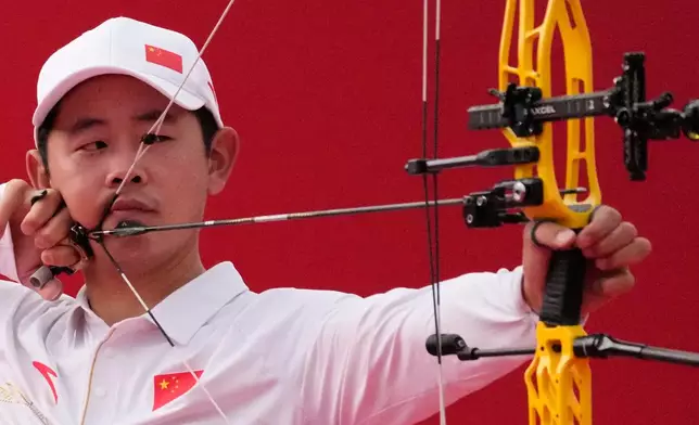 Shi Jingyu of China lines up a shot in the compound men's team semifinal in archery between China and Taiwan, at the Asian Games in Okazaki, Japan, Wednesday, Sept. 30, 2026. (AP Photo/Eugene Hoshiko)