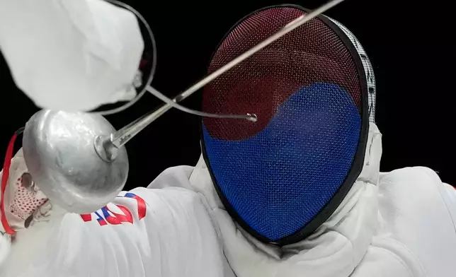 South Korea's Park Sang-young, right, competes against Kazakhstan Yerlik Sertay during the men's epee team final match at the Asian Games in Nagoya, Japan, Sunday, Sept. 27, 2026. (AP Photo/Dita Alangkara)