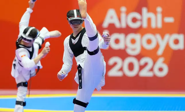 Singapore's Darren Yap Zong Han, right, competes against Kyrgyzstan's Alisher Asymbek Uulu during their mixed individual virtual taekwondo round of 16 match at the Asian Games in Toyohashi, Japan, Friday, Oct. 2, 2026. (AP Photo/Dita Alangkara)