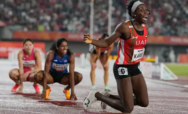 United Arab Emirates' Mariam Kareem reacts after winning the women's 400-meter hurdles final at the Asian Games in Nagoya, Japan, Monday, Sept. 28, 2026. (AP Photo/Dita Alangkara)