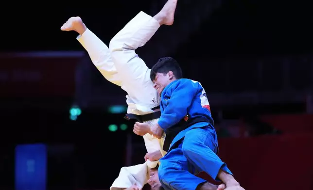 Uzbekistan's Samariddin Kuchkarov, right, fights Tajikistan's Loiq Kudbudinov during the men's judo -60kg bronze match at the Asian Games in Nagoya, Japan, Wednesday, Sept. 30, 2026. (AP Photo/Aaron Favila)