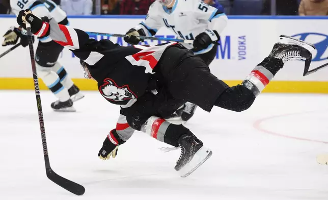 Buffalo Sabres right wing Jack Quinn (22) falls to the ice during the first period of an NHL hockey game against the Utah Mammoth Saturday, Oct. 10, 2026, in Buffalo, N.Y. (AP Photo/Jeffrey T. Barnes)