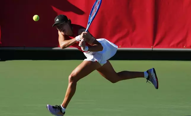 China's Wang Xiyu hits a backhand to China's Zhang Shuai during the Women's singles final tennis match at the Asian Games in Nagoya, Japan, Friday, Oct. 2, 2026. (AP Photo/Aaron Favila)