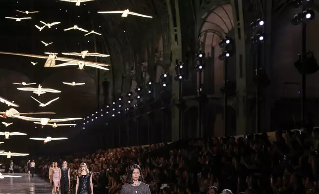 Models wear creations as part of the Chanel Womenswear Spring Summer 2027 collection presented in Paris, France, Monday, Oct. 5, 2026. (AP Photo/Thomas Padilla)