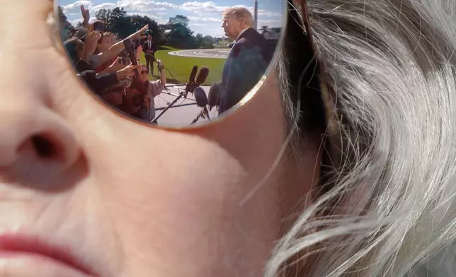 President Donald Trump is pictured in the reflection of White House Chief of Staff Susie Wiles' sunglasses as Trump speaks to reporters on the South Lawn of the White House before departing, Monday, Oct. 5, 2026, in Washington. (AP Photo/Tom Brenner)