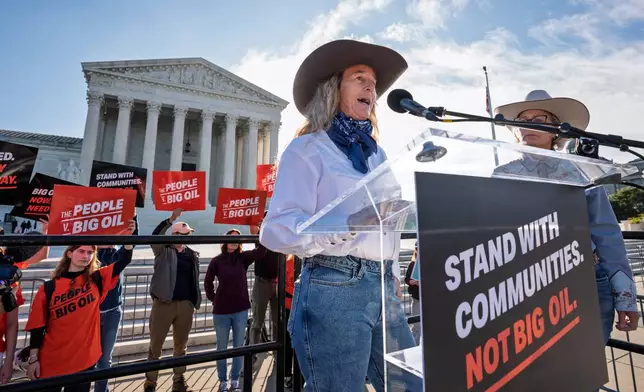 Colorado rancher Kathryn Bedell talks about the impact of droughts on her business as activists gather at the Supreme Court for a case about whether oil and gas companies should help pay for damage caused by disasters linked to climate change, on Capitol Hill in Washington, Monday, Oct. 5, 2026. (AP Photo/J. Scott Applewhite)