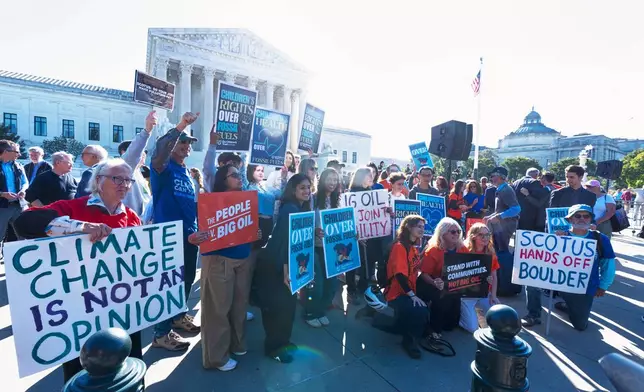Climate activists gather outside the Supreme Court as the Supreme Court hears arguments in Suncor Energy v. Boulder County, Monday, Oct. 5, 2026, in Washington. (AP Photo/Manuel Balce Ceneta)