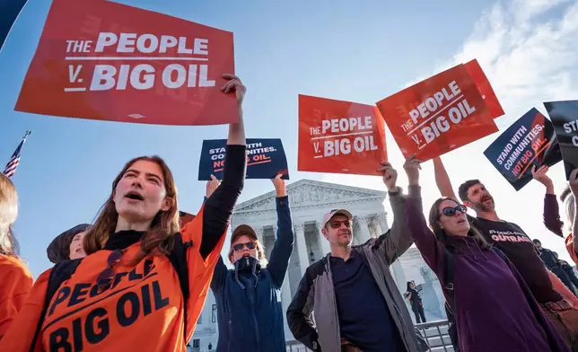 Activists take a stand as the Supreme Court begins its new term with a case about whether oil and gas companies should help pay for damage caused by disasters linked to climate change, on Capitol Hill in Washington, Monday, Oct. 5, 2026. (AP Photo/J. Scott Applewhite)
