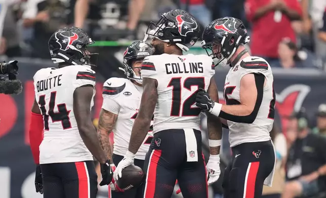 Houston Texans wide receiver Nico Collins, center, celebrates his touchdown during the second half of an NFL football game against the Dallas Cowboys in Houston, Sunday, Oct. 4, 2026. (AP Photo/Ashley Landis)