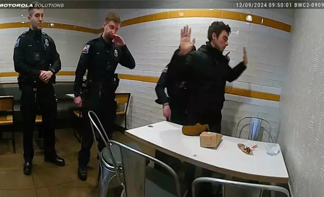 This image, provided by the Altoona Police Department, shows body camera footage of police officers arresting Luigi Mangione in Altoona, Pa., on Dec. 9, 2024.(Altoona Police Department via AP)