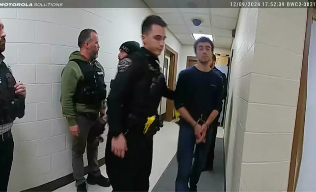 This image, provided by the Altoona Police Department, shows body camera footage of police officers arresting Luigi Mangione in Altoona, Pa., on Dec. 9, 2024. (Altoona Police Department via AP)