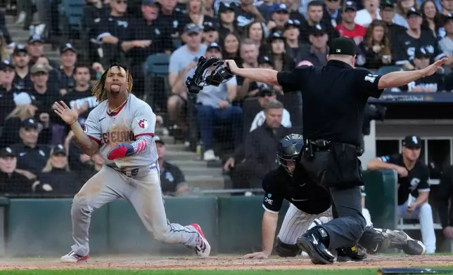 Cleveland Guardians' José Ramírez, left, celebrates after scoring on a fielder's choice by Chase DeLauter during the fifth inning in Game 3 of baseball's American League Division Series against the Chicago White Sox Wednesday, Oct. 7, 2026, in Chicago. (AP Photo/Nam Y. Huh)