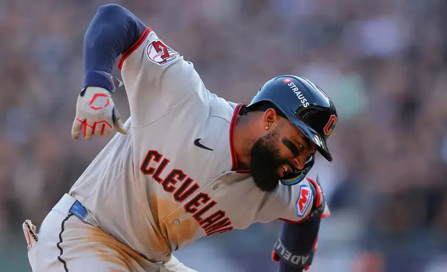 Cleveland Guardians' Jo Adell celebrates after hitting a three-run triple against Chicago White Sox pitcher Hagen Smith during the third inning in Game 3 of baseball's American League Division Series Wednesday, Oct. 7, 2026, in Chicago. (AP Photo/Melissa Tamez)