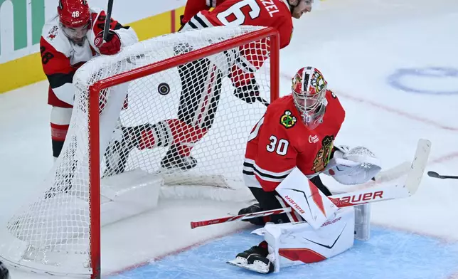 Chicago Blackhawks goalie Spencer Knight misses a goal scored by Carolina Hurricanes' Jackson Blake during the second period of an NHL hockey game Saturday, Oct. 10, 2026, in Chicago. (AP Photo/Paul Beaty)