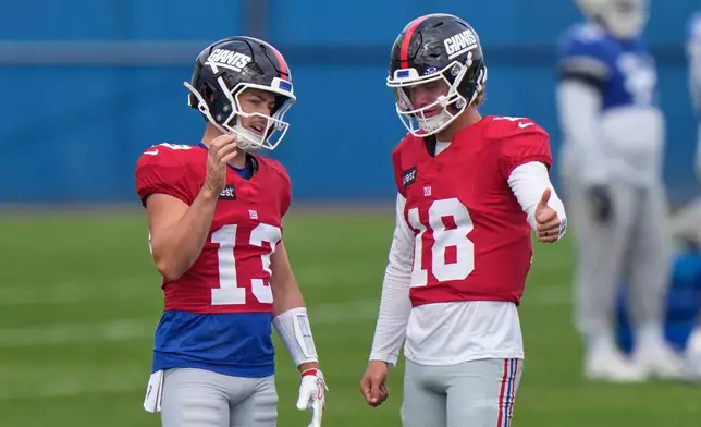 New York Giants' quarterback J.J. McCarthy, right, talks with Jake Haener during a practice at the team's NFL football facilities in East Rutherford, N.J., Wednesday, Sept. 30, 2026. (AP Photo/Seth Wenig)