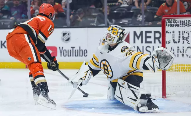 Anaheim Ducks center Nikita Nesterenko, left, is unable to score against Boston Bruins goaltender Michael DiPietro, right, during the second period of an NHL hockey game Friday, Oct. 16, 2026, in Anaheim, Calif. (AP Photo/Ryan Sun)