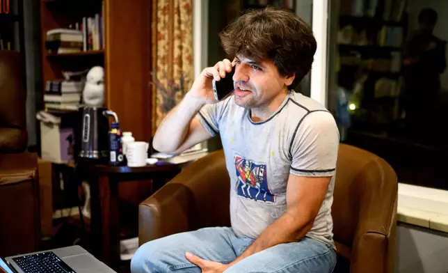 Karl Deisseroth, one of the three recipients of the 2026 Nobel Prize in medicine, talks on his mobile at home on Monday, Oct. 5, 2026, in Stanford, Calif. (AP Photo/Noah Berger)
