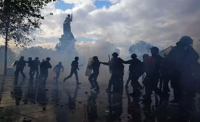 Police scuffle with protesters during a demonstration against rising living costs, joining students' grievances, in Paris, Saturday, Oct. 17, 2026. (AP Photo/Thibault Camus)