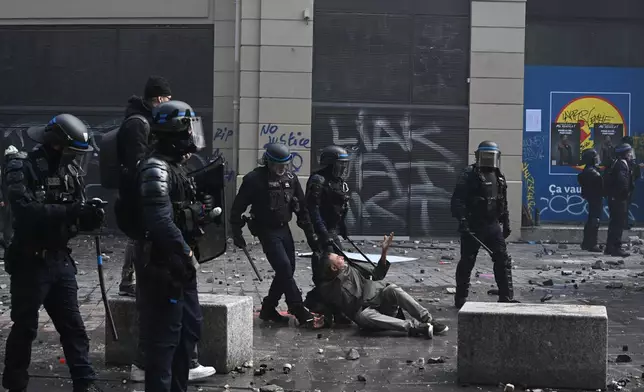 Police detain a protester during a demonstration against rising living costs and students' grievances, in Paris, Saturday, Oct. 17, 2026. (AP Photo/Emma Da Silva)