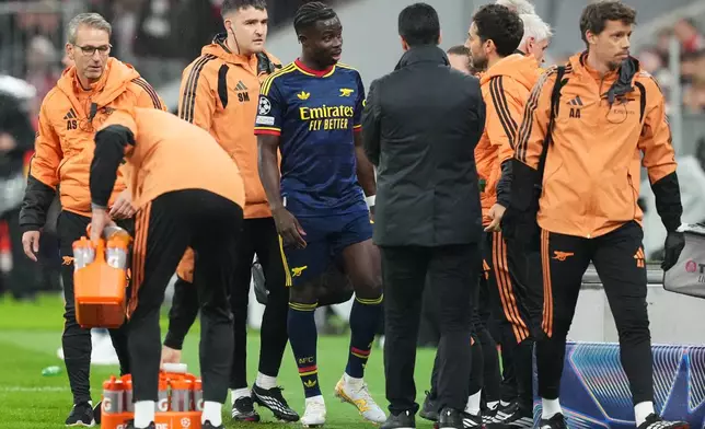 Arsenal's Bukayo Saka walks off the pitch after an injury during the UEFA Champions League soccer match between Bayern and Arsenal in Munich Germany, Wednesday, Oct. 21, 2026. (AP Photo/Martin Meissner)