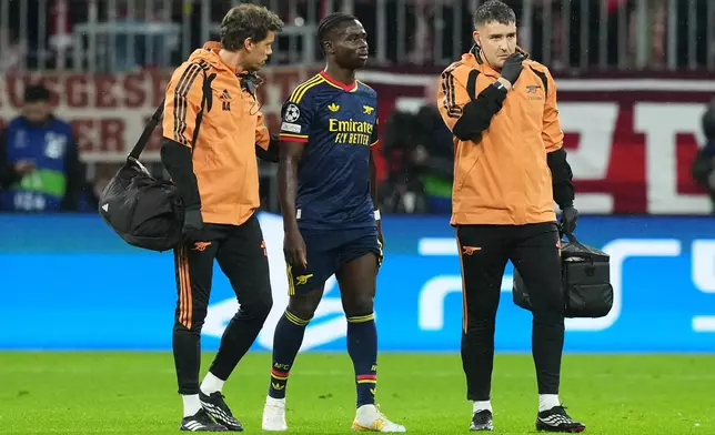 Arsenal's Bukayo Saka walks off the pitch after an injury during the UEFA Champions League soccer match between Bayern and Arsenal in Munich Germany, Wednesday, Oct. 21, 2026. (AP Photo/Martin Meissner)