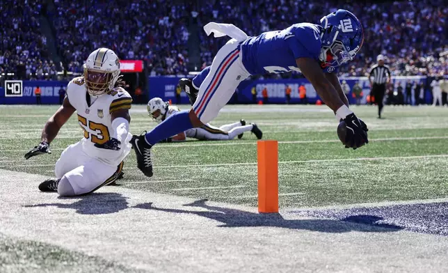 New York Giants running back Tyrone Tracy Jr. (29) scores a touchdown during the first half of an NFL football game against the New Orleans Saints in East Rutherford, N.J., Sunday, Oct. 18, 2026. (AP Photo/Adam Hunger)