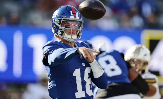 New York Giants quarterback J.J. McCarthy (18) throws during the second half of an NFL football game against the New Orleans Saints in East Rutherford, N.J., Sunday, Oct. 18, 2026. (AP Photo/Adam Hunger)