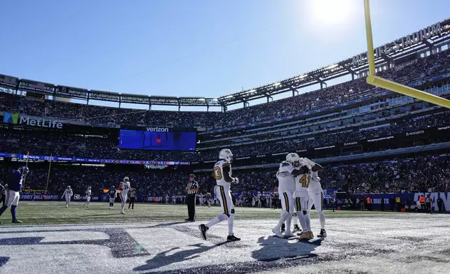 New Orleans Saints running back Alvin Kamara (41) celebrates with teammates after scoring a touchdown during the second half of an NFL football game against the New York Giants in East Rutherford, N.J., Sunday, Oct. 18, 2026. (AP Photo/Adam Hunger)