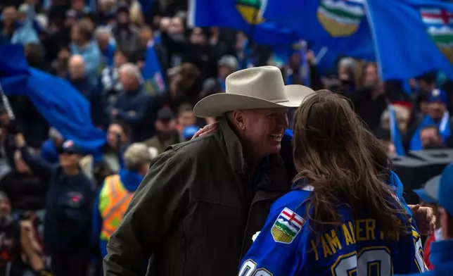 Jeffrey Rath greets speakers during an Alberta independence rally at the Alberta legislature in Edmonton Alberta, Saturday, Oct. 17, 2026. (Amanda May Erickson/The Canadian Press via AP)