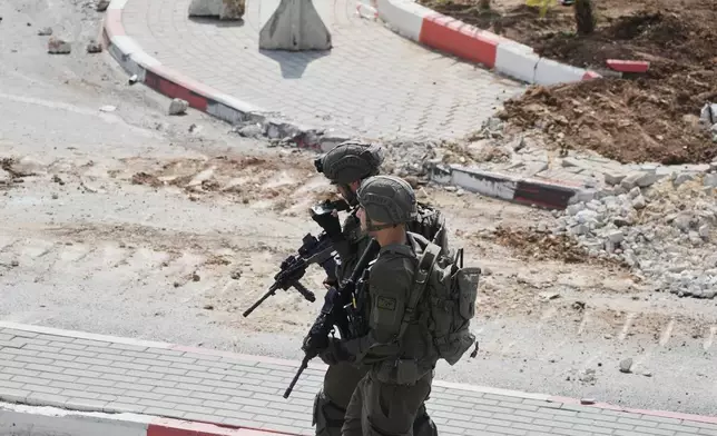 Israeli soldiers take up positions during an army operation in the West Bank city of Hebron Saturday, Oct. 24, 2026. A day after a Palestinian shooting attack in the area. (AP Photo/Mahmoud Illean)
